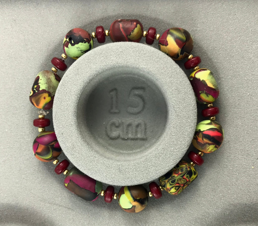 Handmade polymer clay bracelet shown with 15 cm size reference for accurate fit and scale.