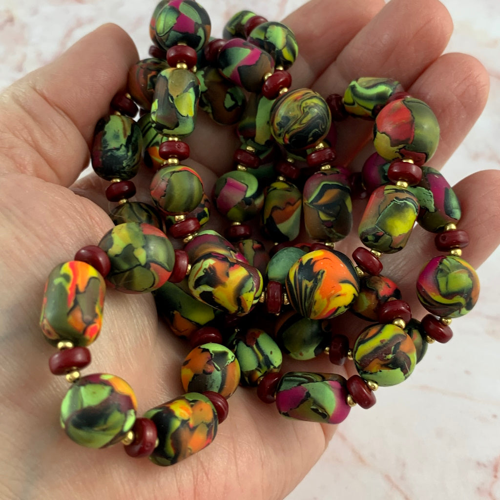 Close-up of long polymer clay necklace showing handcrafted bead shape, smooth finish, and unique artisan design.