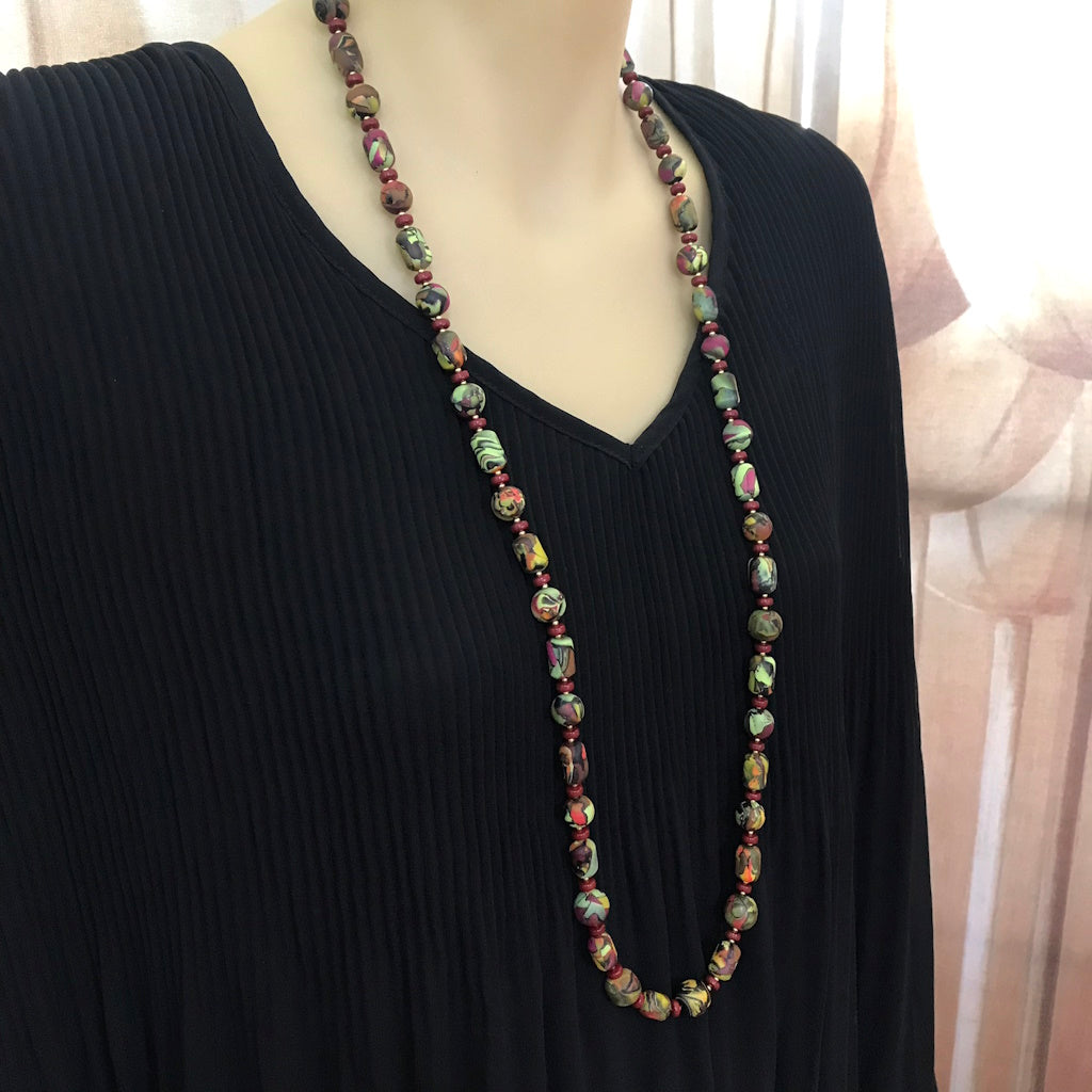 photo on model wearing long Rennique polymer clay summer inspired necklace