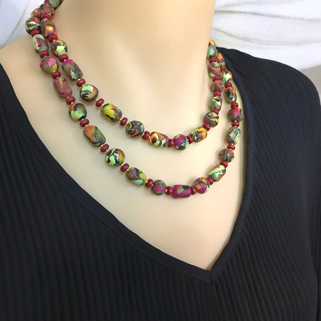 Handmade long polymer clay necklace worn doubled around the neck as a shorter layered statement piece.