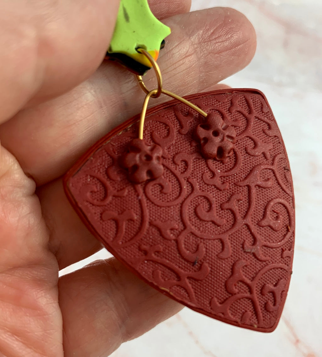 Detailed back view of one-of-a-kind polymer clay pendant with textured finish.