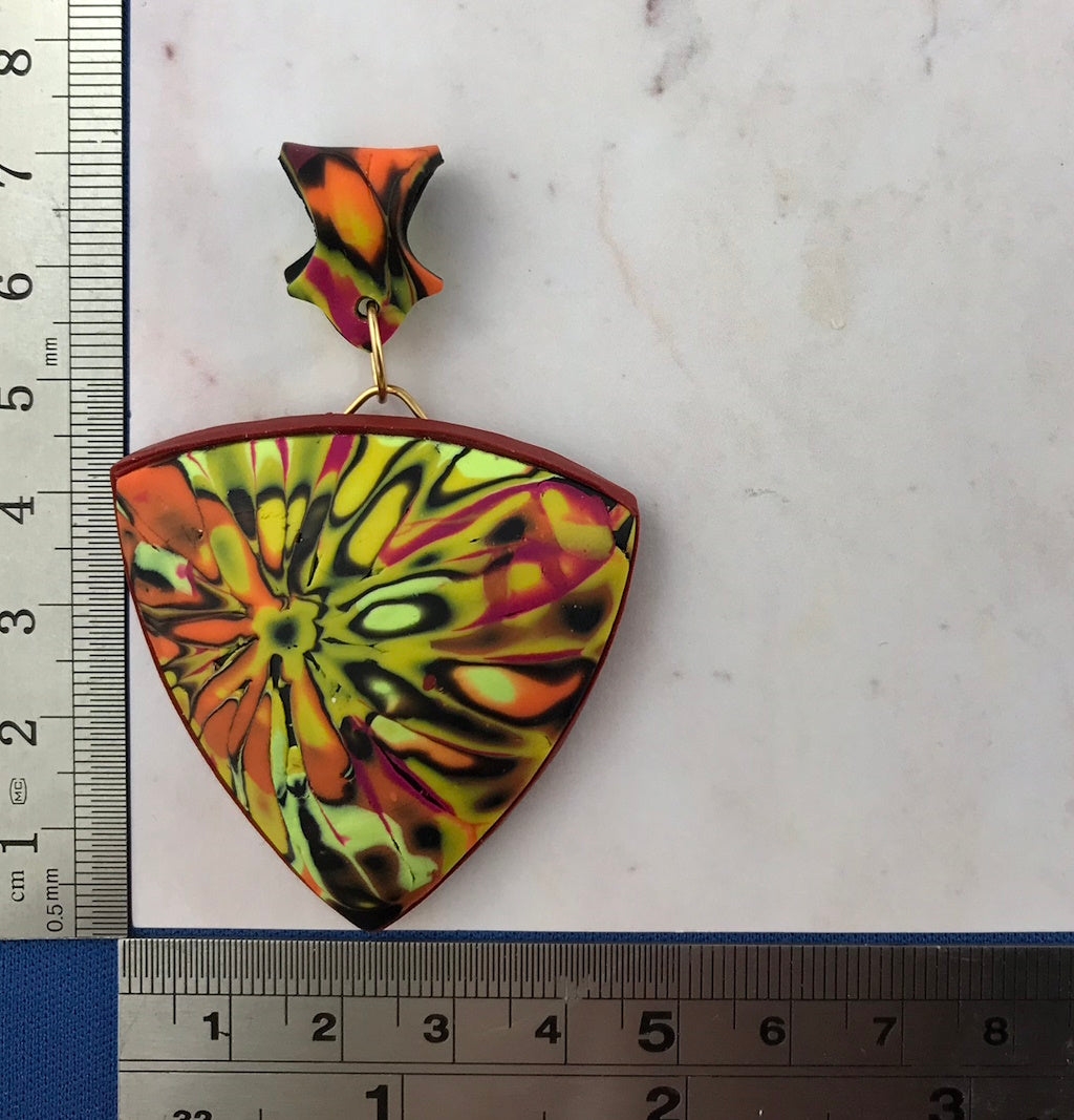 Handmade curved pendant necklace shown with ruler for size reference and accurate scale.