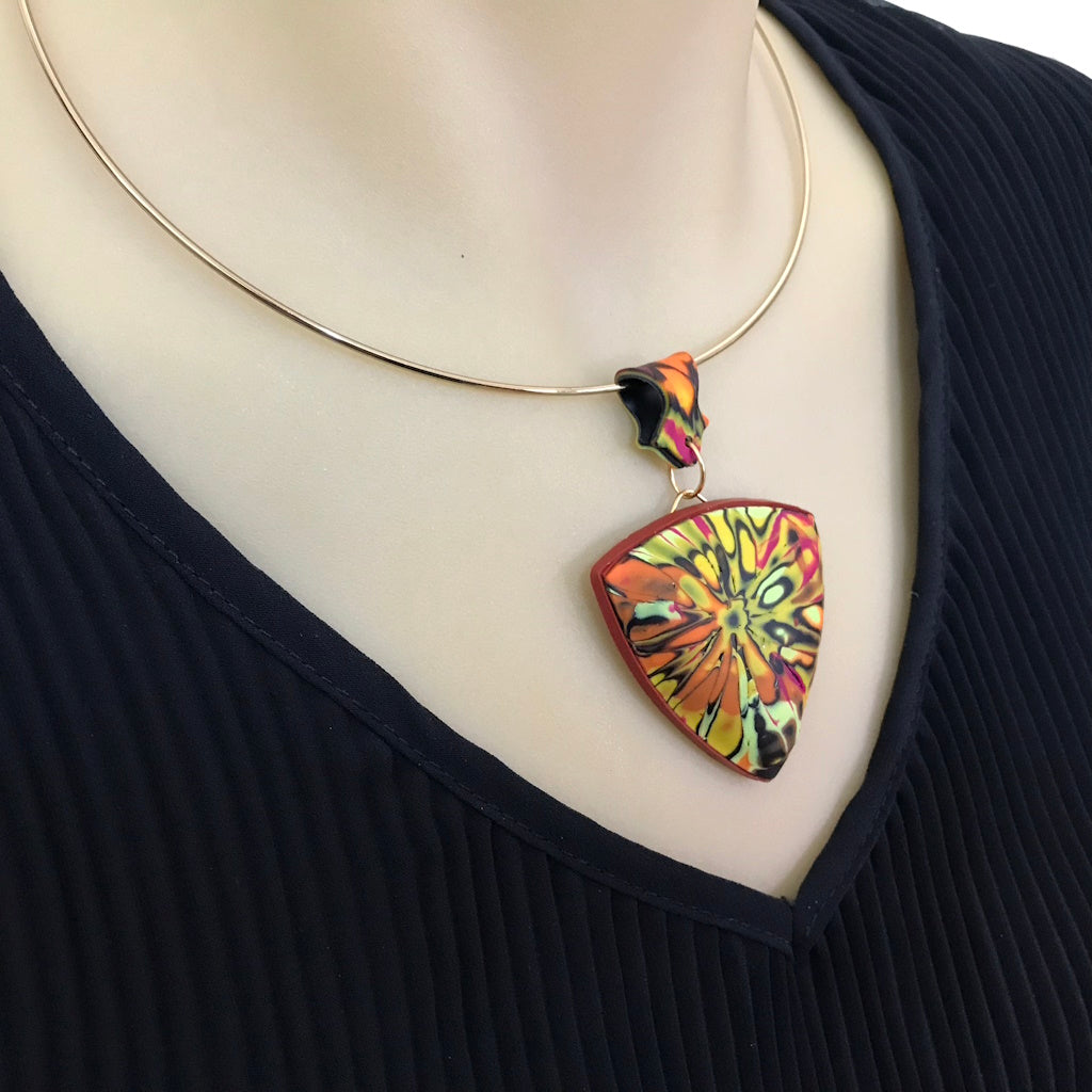 One-of-a-kind handmade curved pendant necklace worn on neckline, showing lightweight sculptural design.