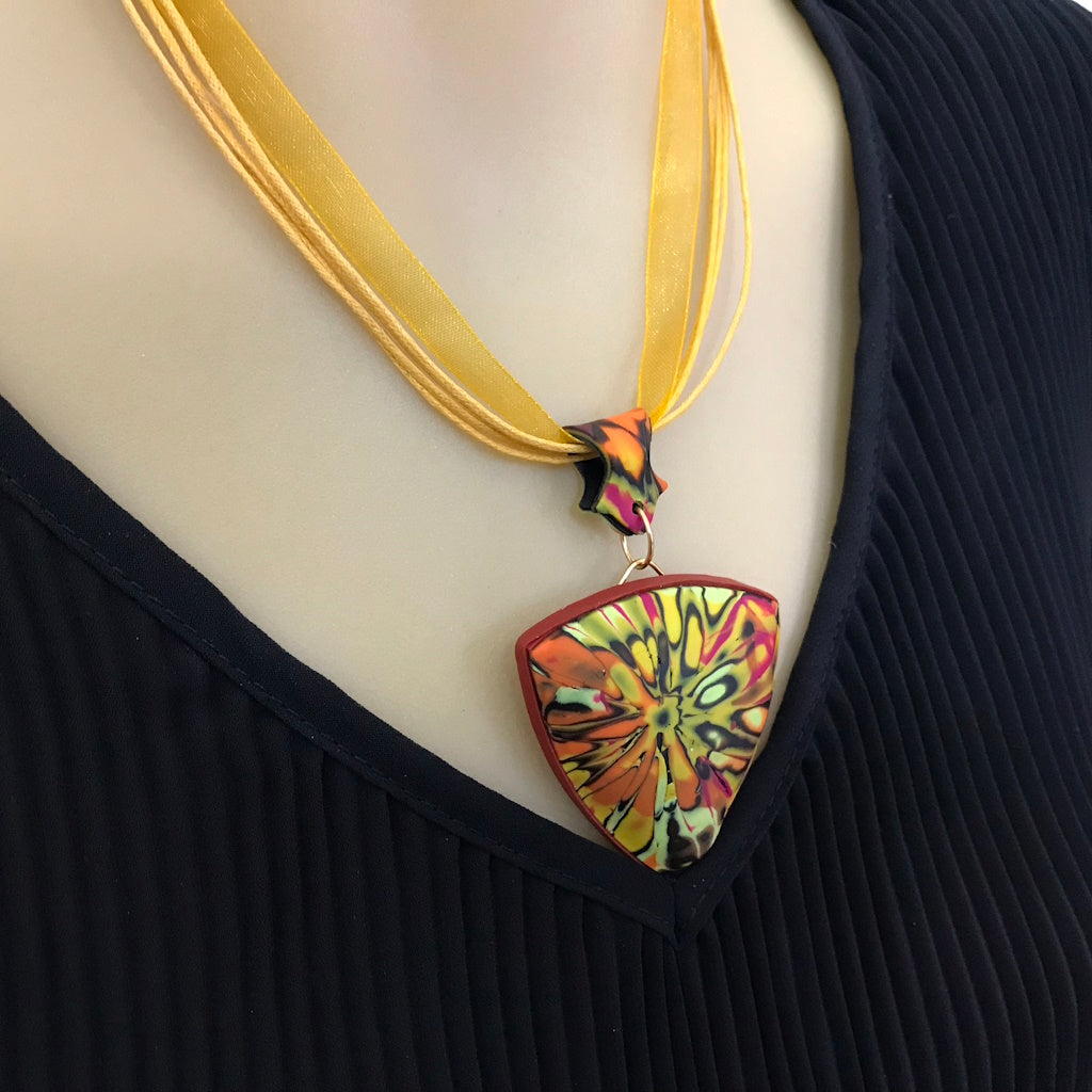 Artisan summer pendant necklace worn with outfit styling, highlighting curved front shape.