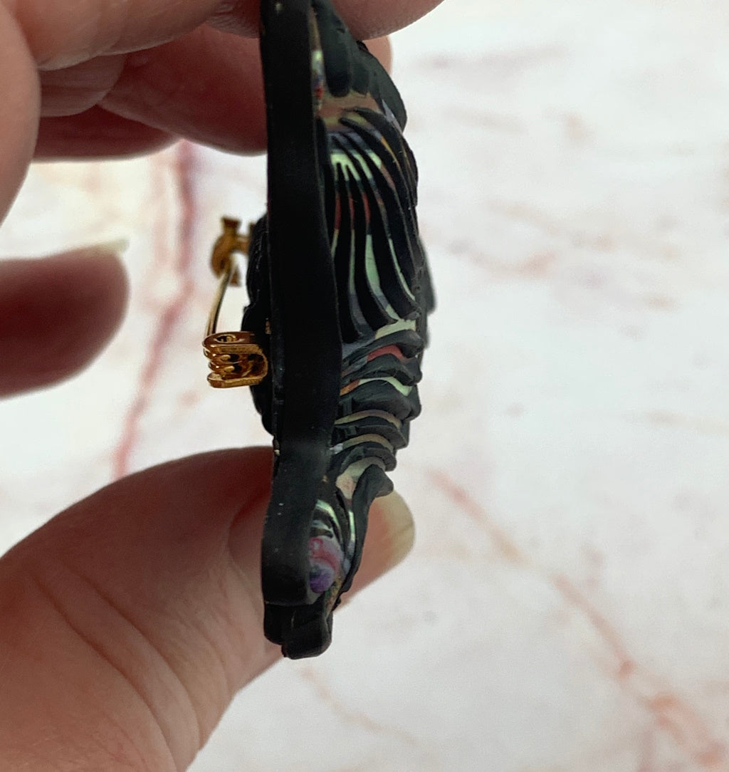 Close up of handmade kitty cat brooch with detailed fur texture and multicolour pattern on black base