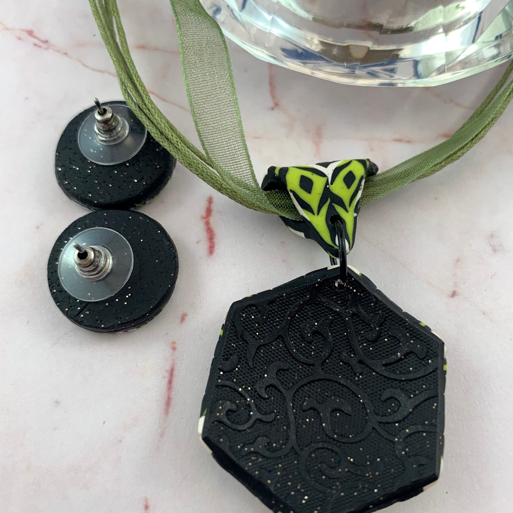Rennique polymer clay pendant necklace reverse textured black finish with matching lime green mandala stud earrings.