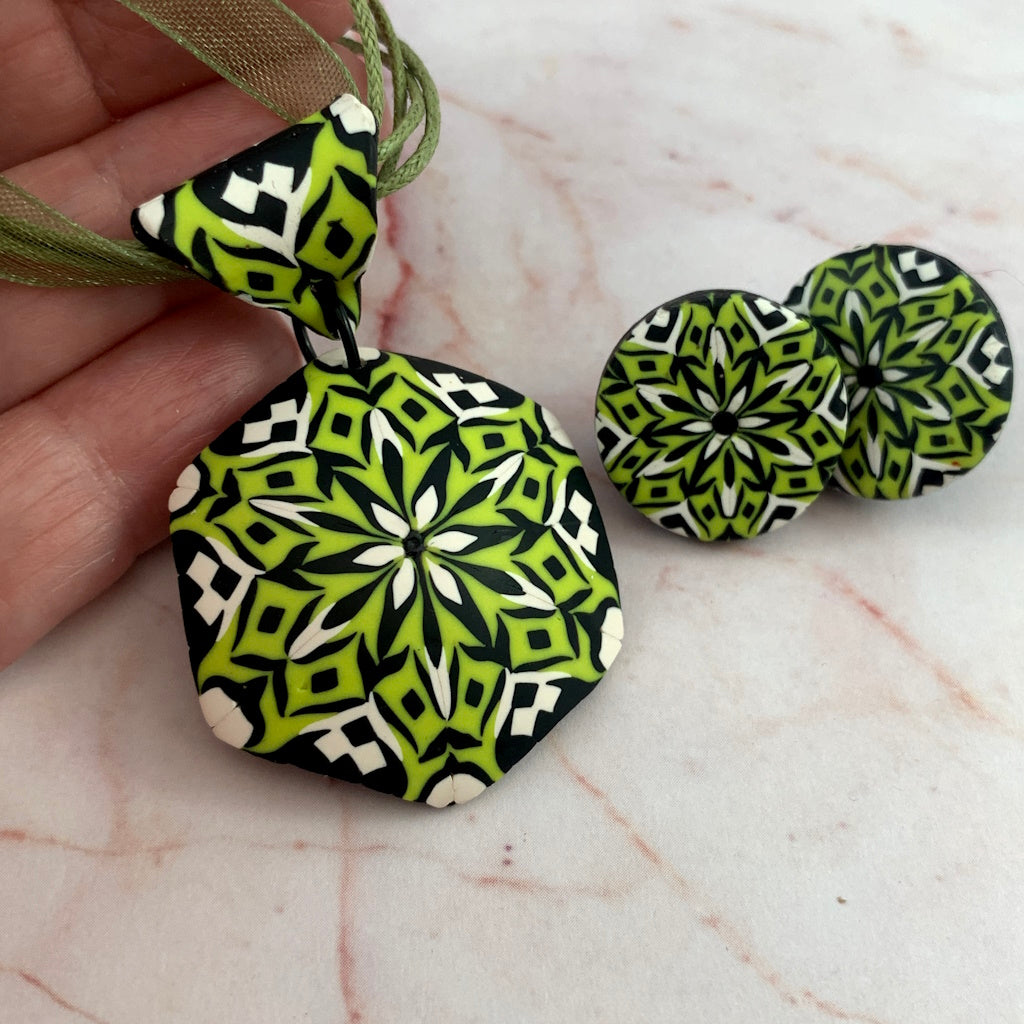 Rennique artisan polymer clay jewellery set featuring lime green pendant necklace and matching earrings in bold geometric mandala pattern.