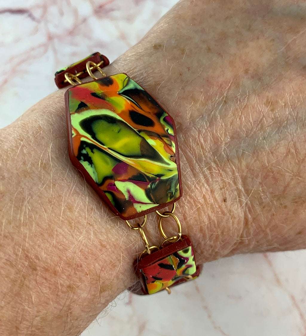 Angled front view of one-of-a-kind Summer Link Bracelet showing curved artisan polymer clay links.