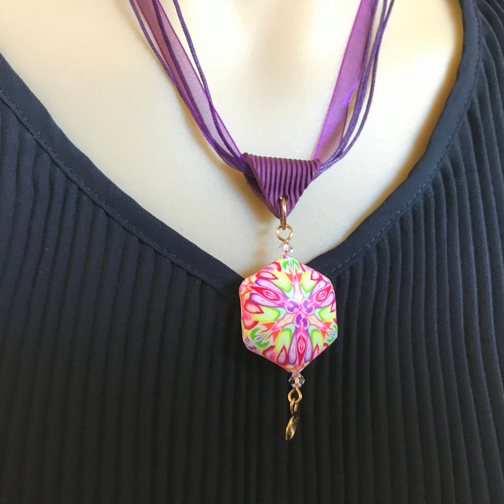 Handmade polymer clay necklace worn, showing bold floral design and artisan craftsmanship