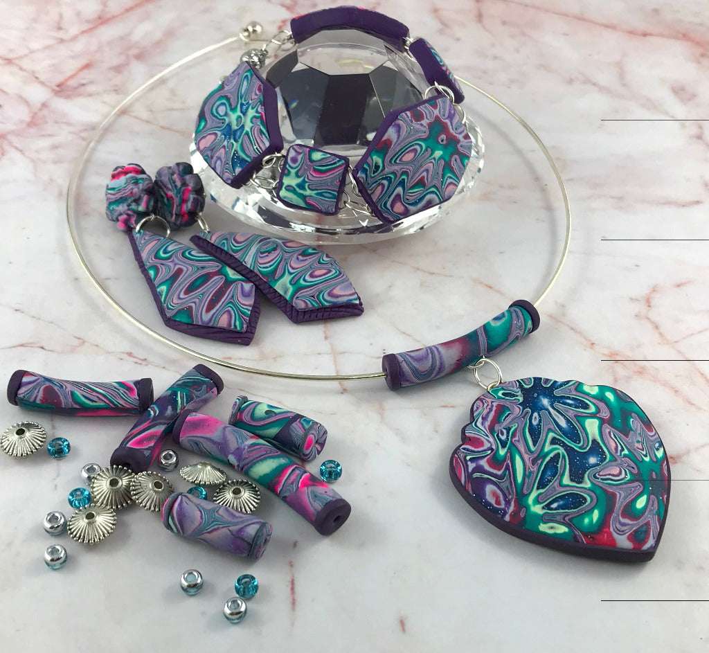 One-of-a-kind handmade polymer clay jewellery set with heart pendant necklace, matching bracelet and drop earrings in purple teal and pink swirl design