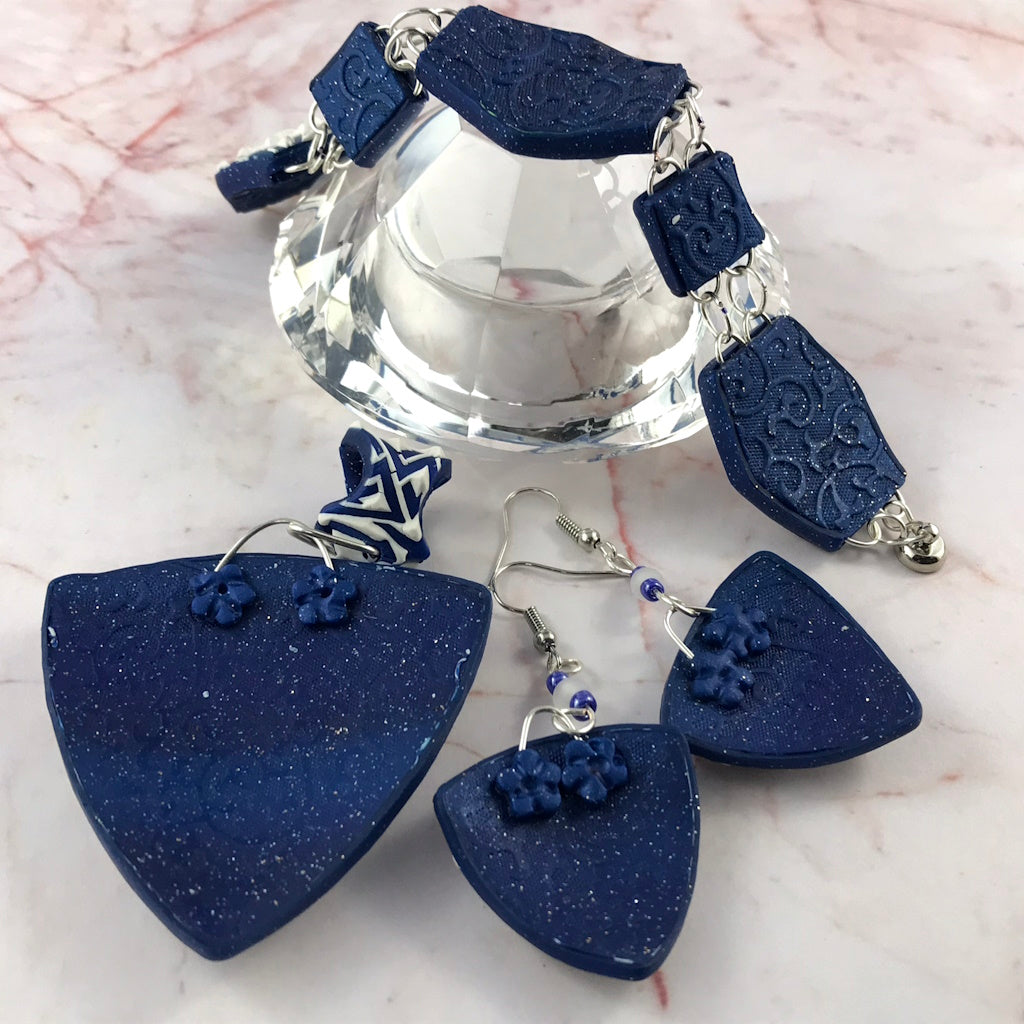 Back view of coordinated polymer clay jewellery set showing navy textured artisan finish.