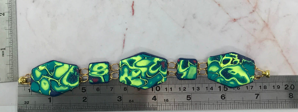 Handmade polymer clay bracelet in neon green, navy and pink swirl pattern with magnetic clasp, artisan statement jewellery Australia