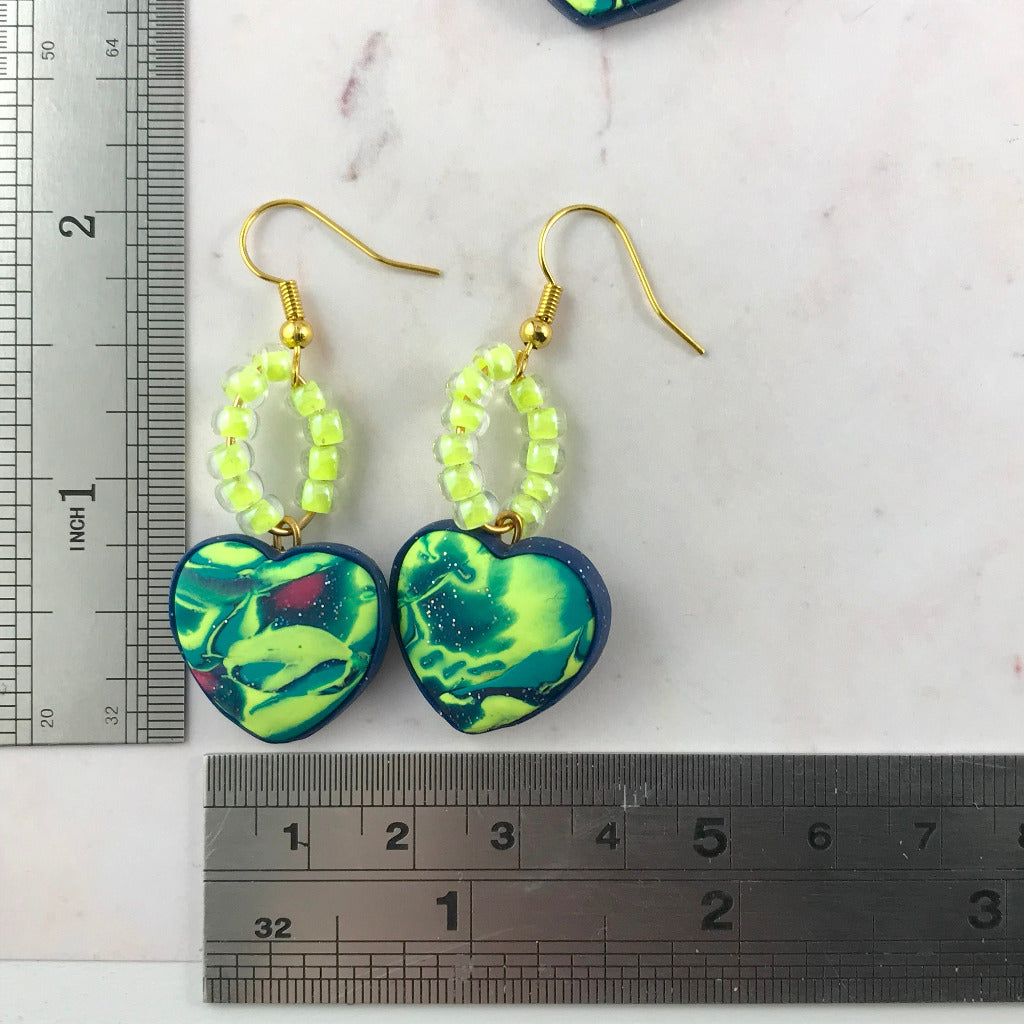 Handmade heart earrings with neon green and navy marbled polymer clay and bead detail, unique artisan earrings Australia