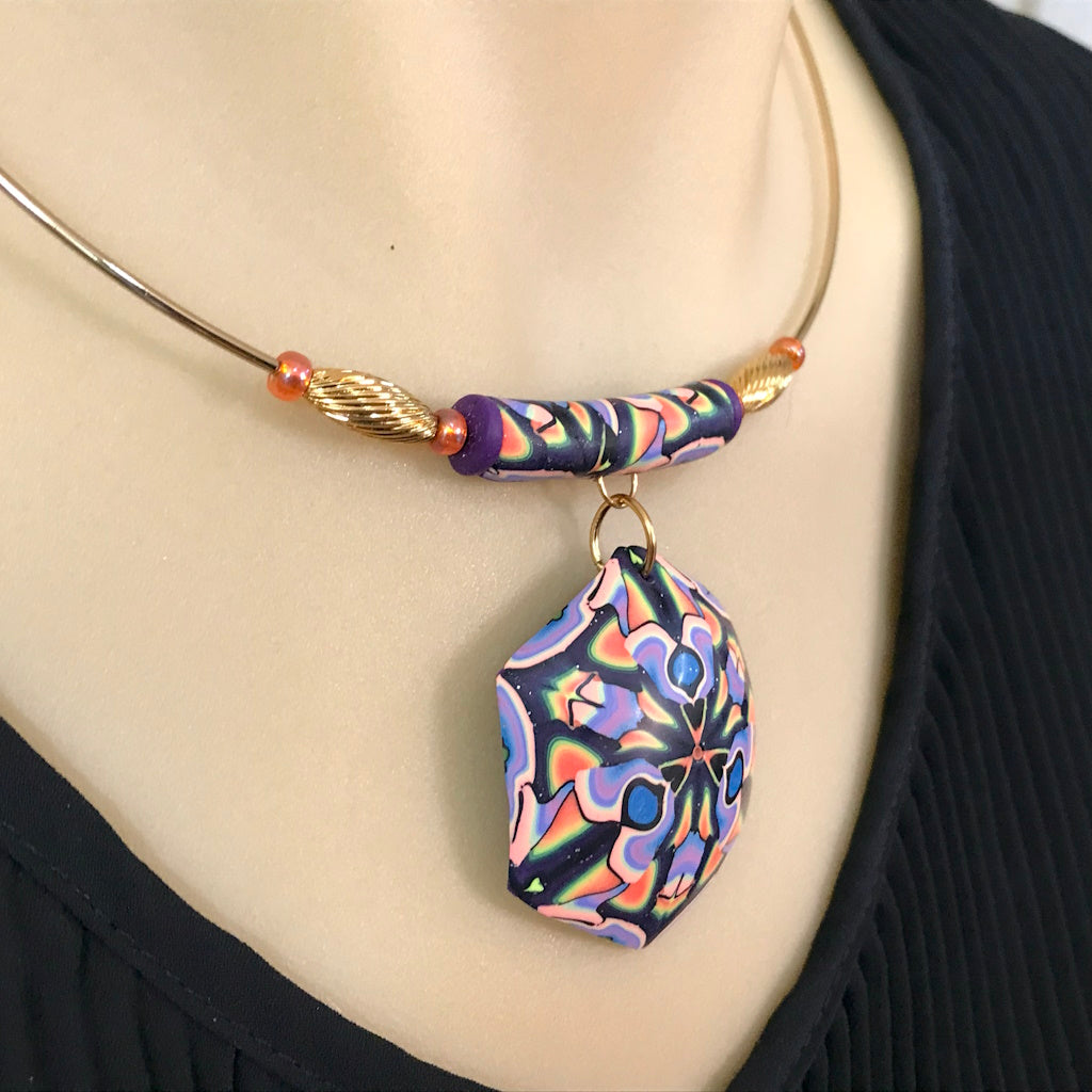 Side profile of handmade colourful necklace showing curved fit and bead placement.
