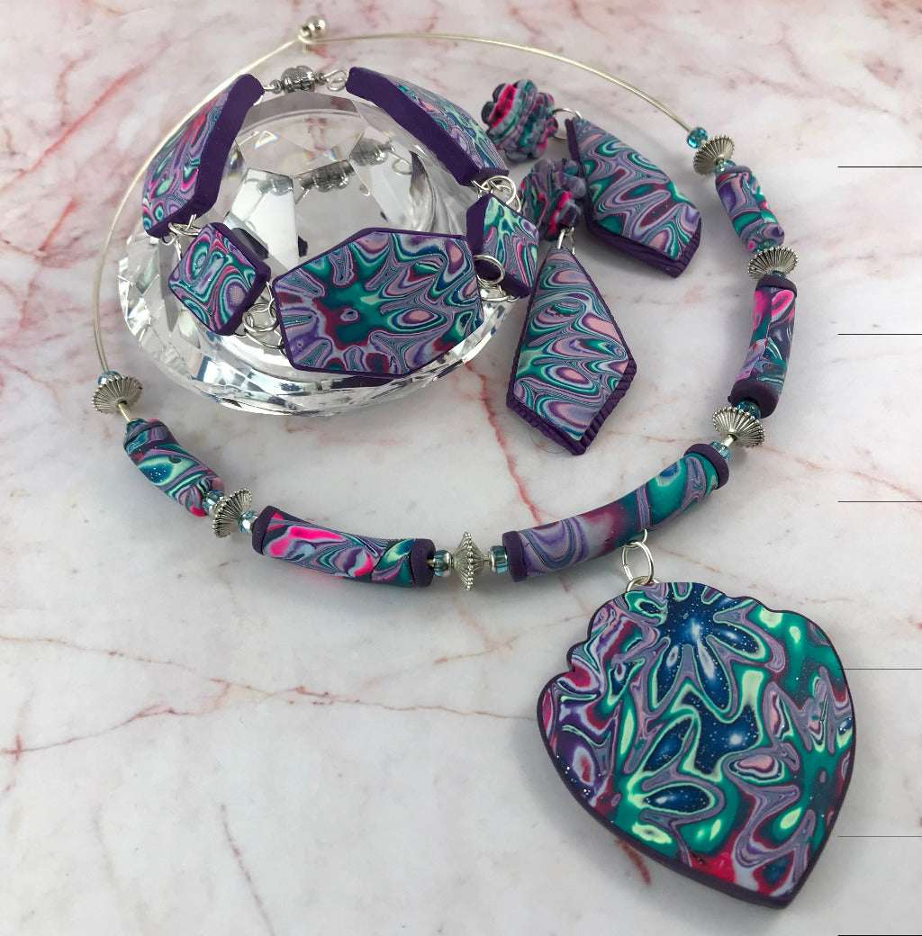 Handmade Cosmic Flower changeable polymer clay jewellery set featuring heart pendant necklace, bracelet and matching earrings in purple, teal and pink marbled design, artisan jewellery Australia