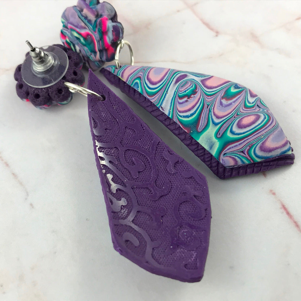 Front and back view of handmade purple dangle earrings in polymer clay with marbled teal and pink swirl design, statement earrings Australia