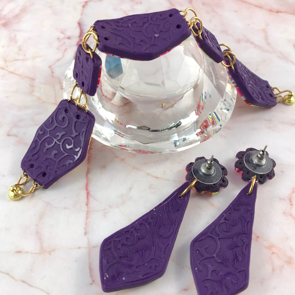 Back view of handmade floral polymer clay jewellery set featuring matching bracelet and drop earrings by Rennique Australia.