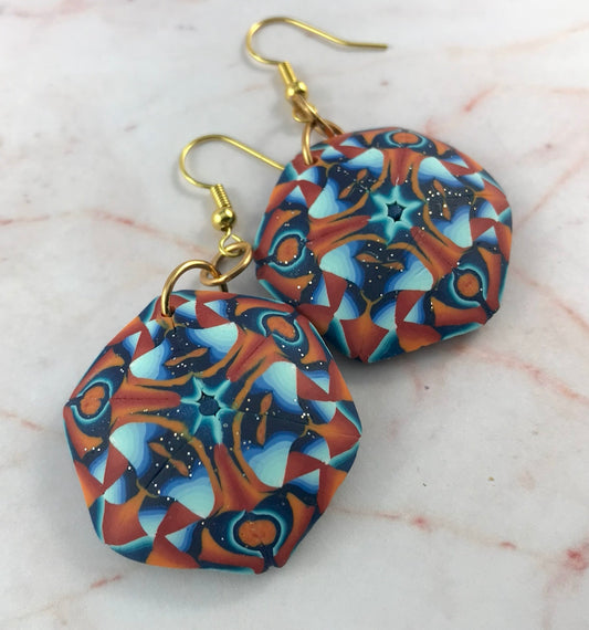 Detailed back view of handmade polymer clay statement earrings showing smooth navy blue finish, thickness and gold hook findings.