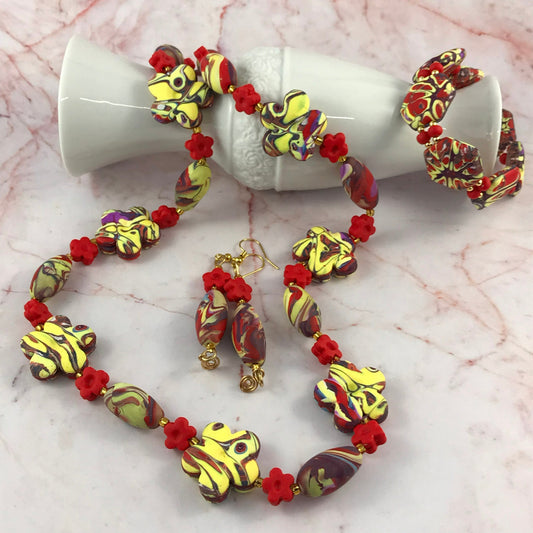 Handmade red and yellow polymer clay jewellery set hero image featuring necklace bracelet and earrings