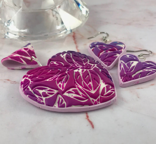 Large pink heart pendant and matching earrings set in handmade polymer clay with pink and purple gradient tones.