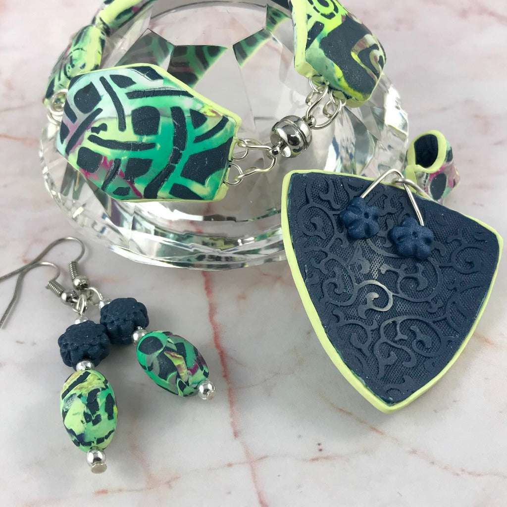 Handmade Melbourne laneway jewellery set featuring bracelet, matching earrings and back view of textured statement pendant in green and black polymer clay, artisan jewellery Australia