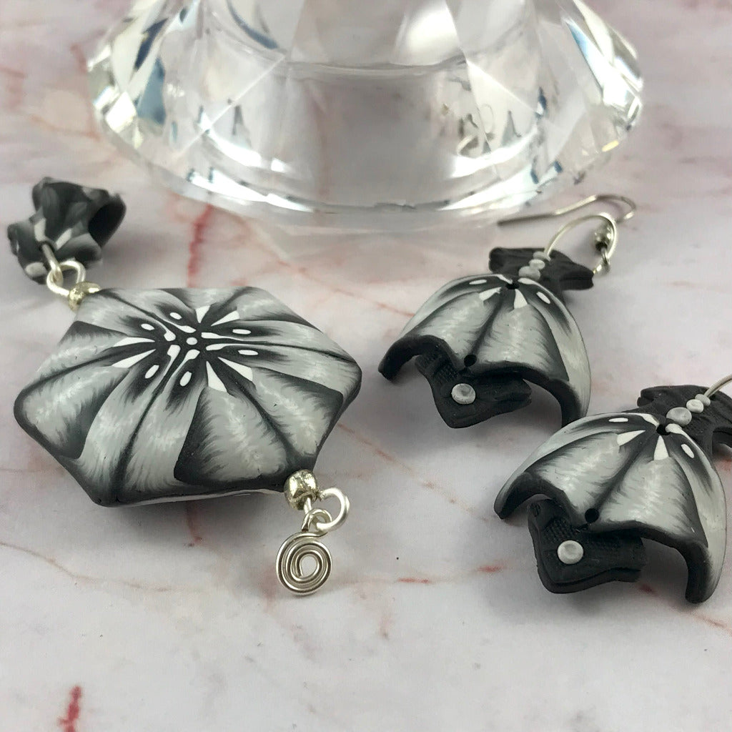 Close-up of one of a kind black white polymer clay jewellery set featuring handcrafted statement pendant and matching earrings, Australian artisan jewellery