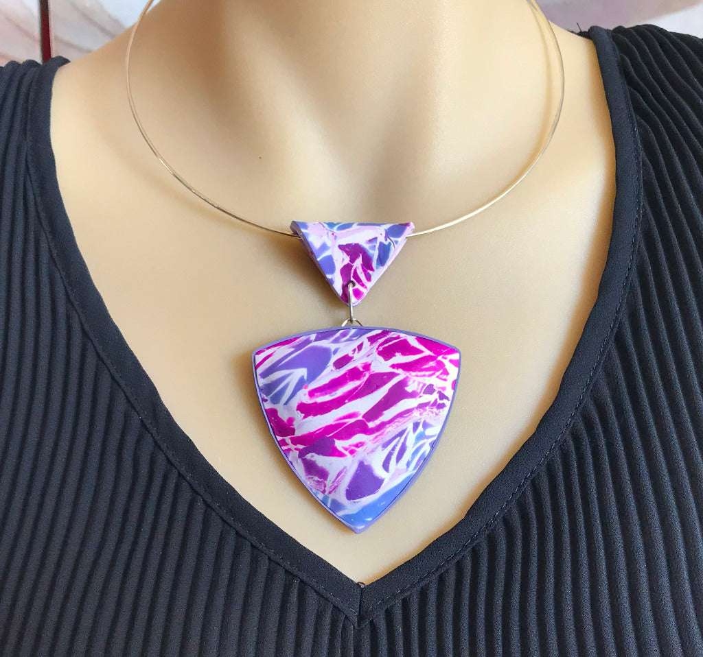 Handmade purple pink marbled polymer clay statement pendant necklace worn on silver neck ring, artisan jewellery Australia