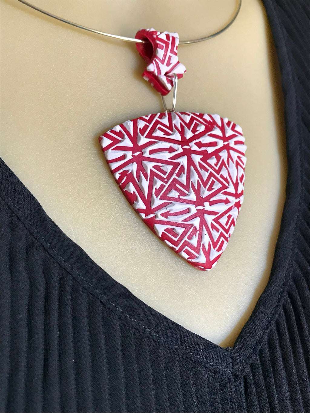 Red and white textured polymer clay pendant necklace worn on mannequin showing size, drape, and fit.