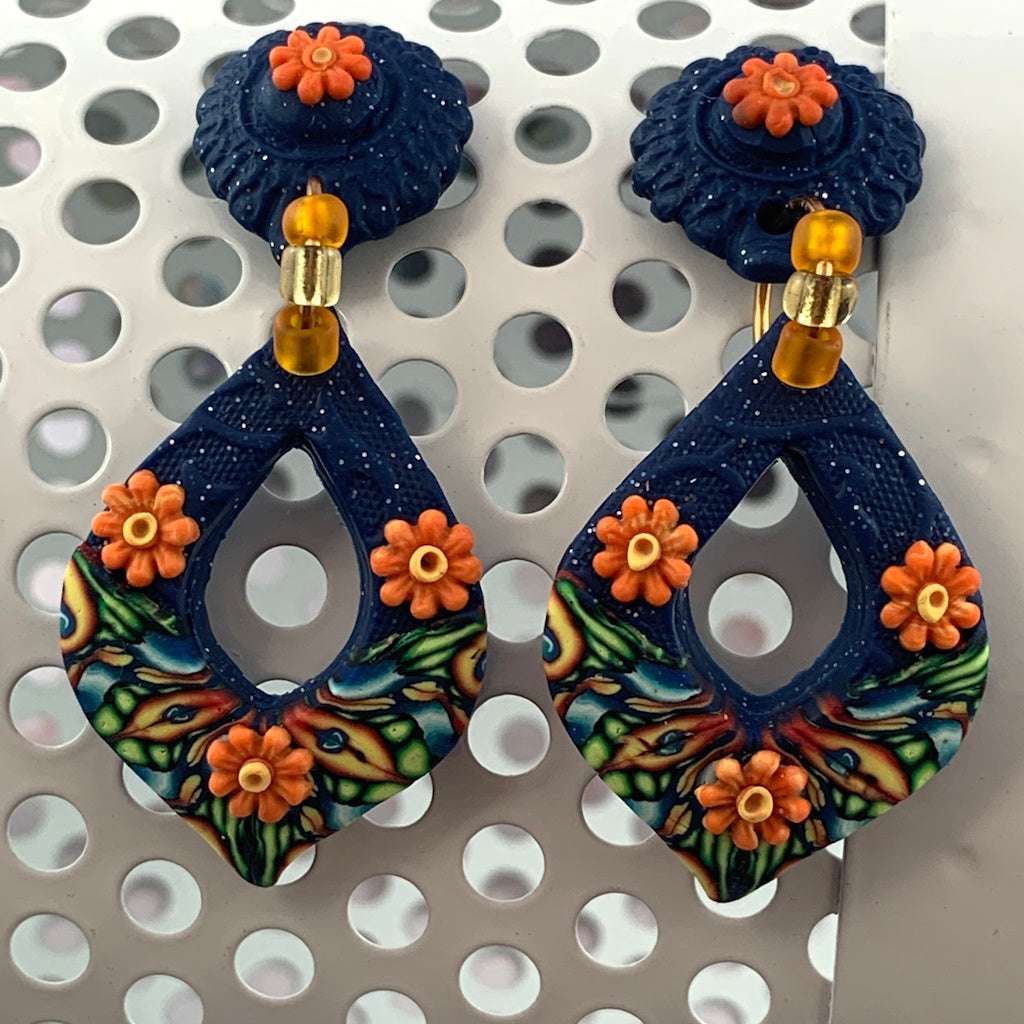 Award-winning Rennique hand-sculpted blue teardrop statement earrings with orange floral accents and artisan designer finish.