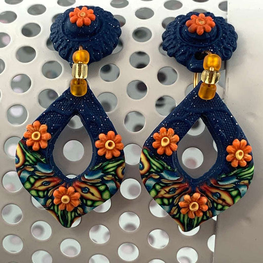 Award-winning Rennique hand-sculpted blue teardrop statement earrings with orange floral accents and artisan designer finish.