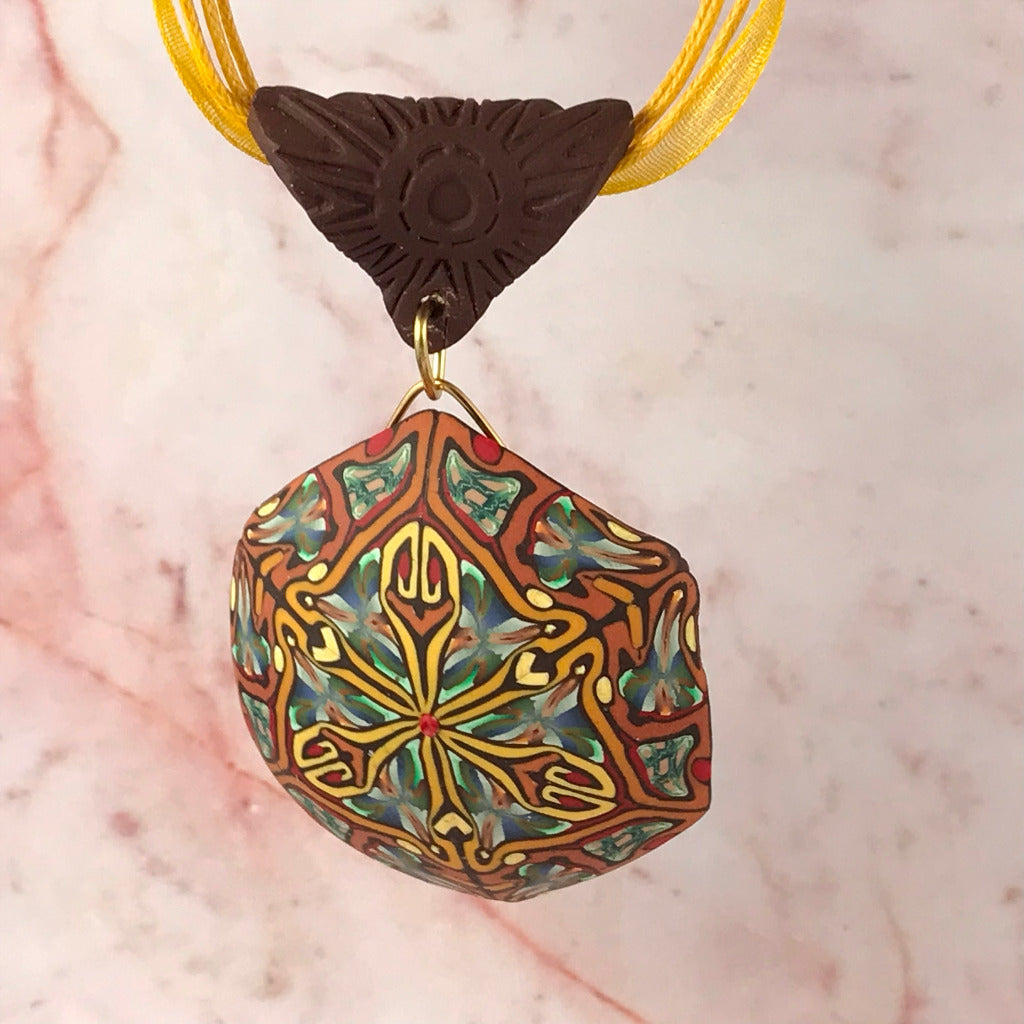 Rennique autumn tone feature polymer clay pendant with abstract geometric art pattern in warm rust, gold, olive green and terracotta tones