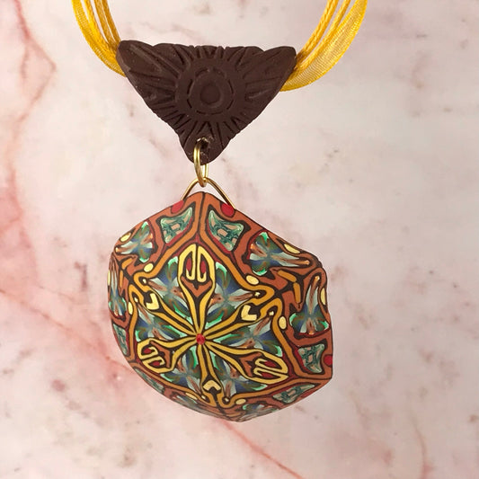 Rennique autumn tone feature polymer clay pendant with abstract geometric art pattern in warm rust, gold, olive green and terracotta tones