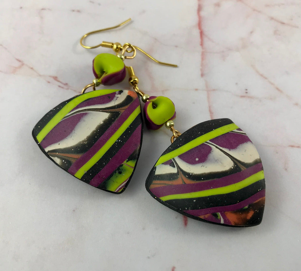 Matching abstract patchwork polymer clay earrings in bold artisan design.