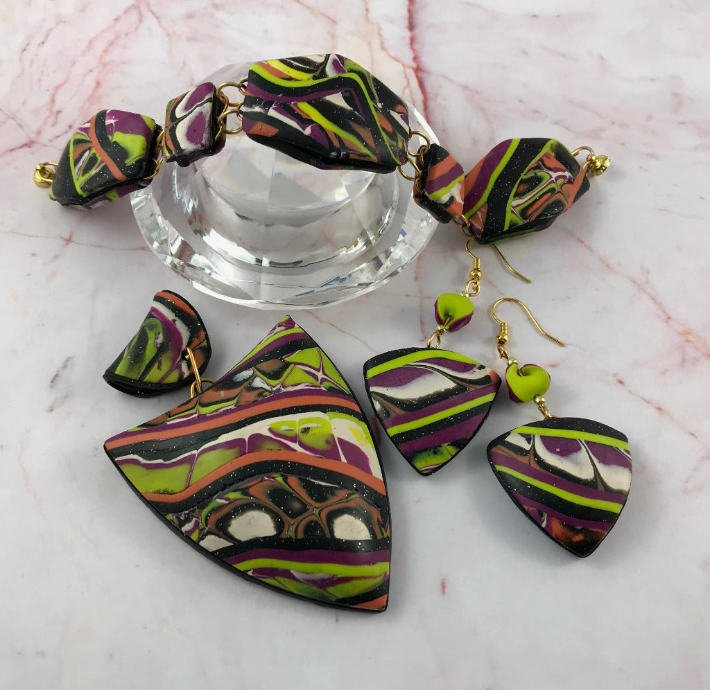Alternative view of bold abstract pendant, bracelet, and earrings set in polymer clay.