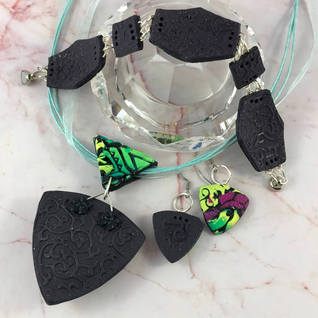 Rennique modern patchwork polymer clay jewellery set showing textured black patterned back finish of pendant and bracelet