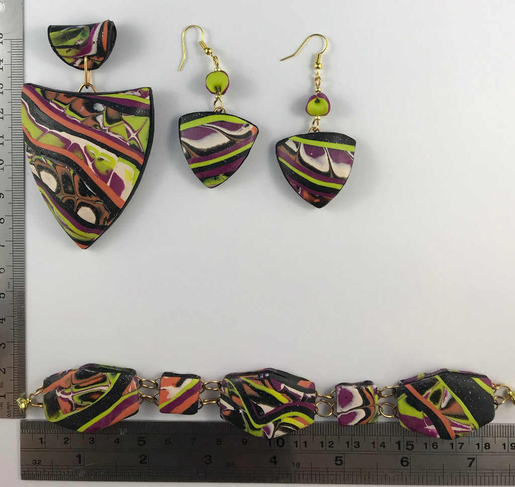 Pendant, bracelet, and earrings set with ruler showing full size measurement.