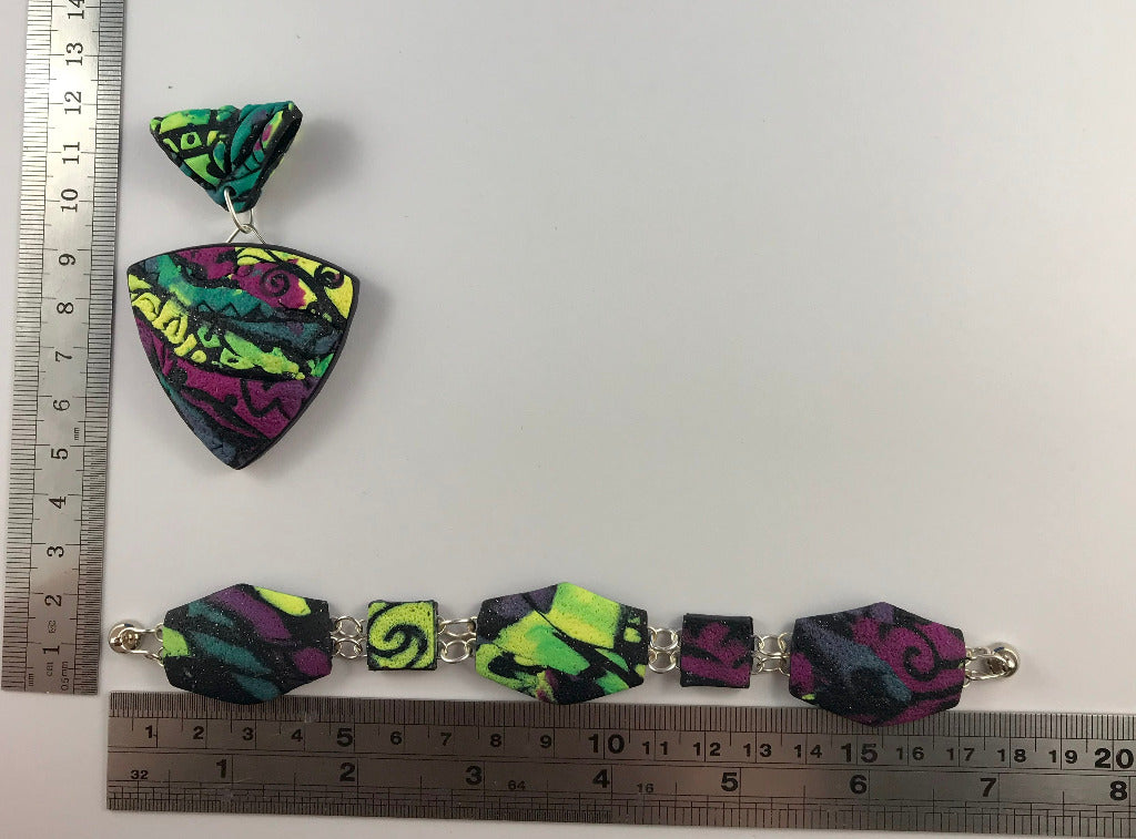 Rennique handmade modern patchwork polymer clay statement pendant with matching geometric bracelet in bold purple, green and black tones