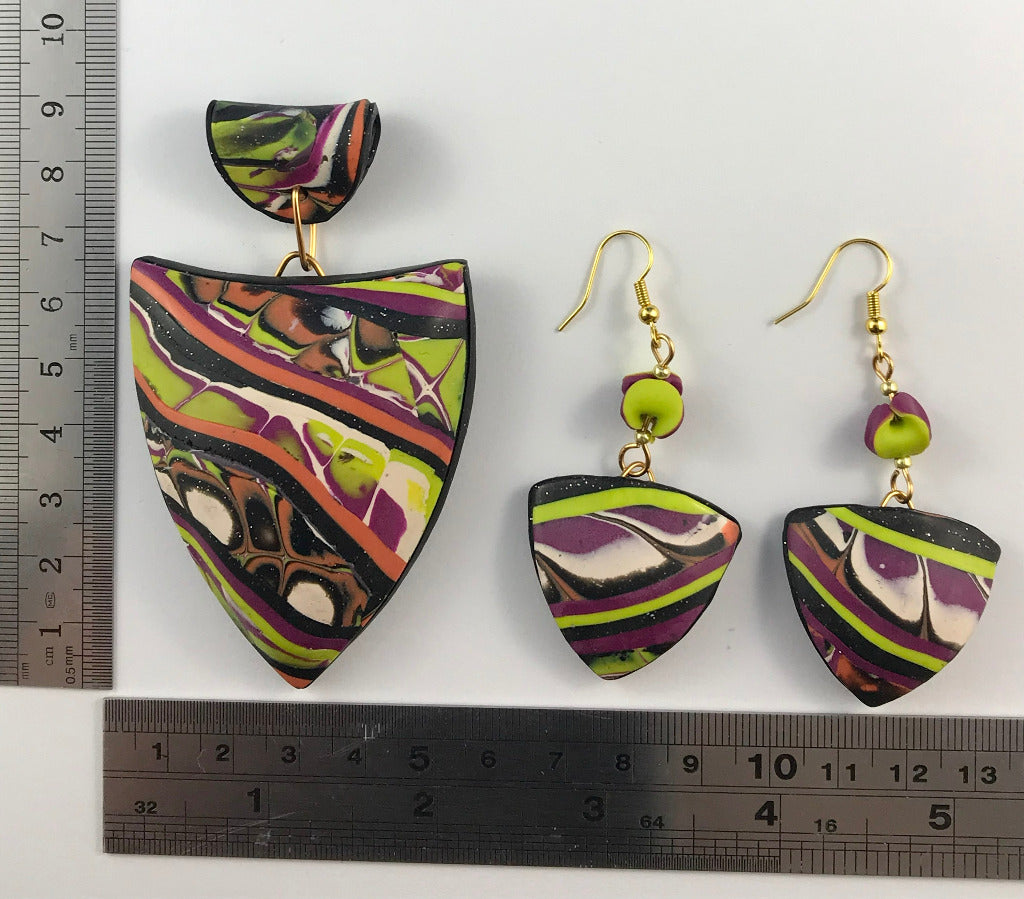 Patchwork pendant and earrings displayed with ruler for size reference.