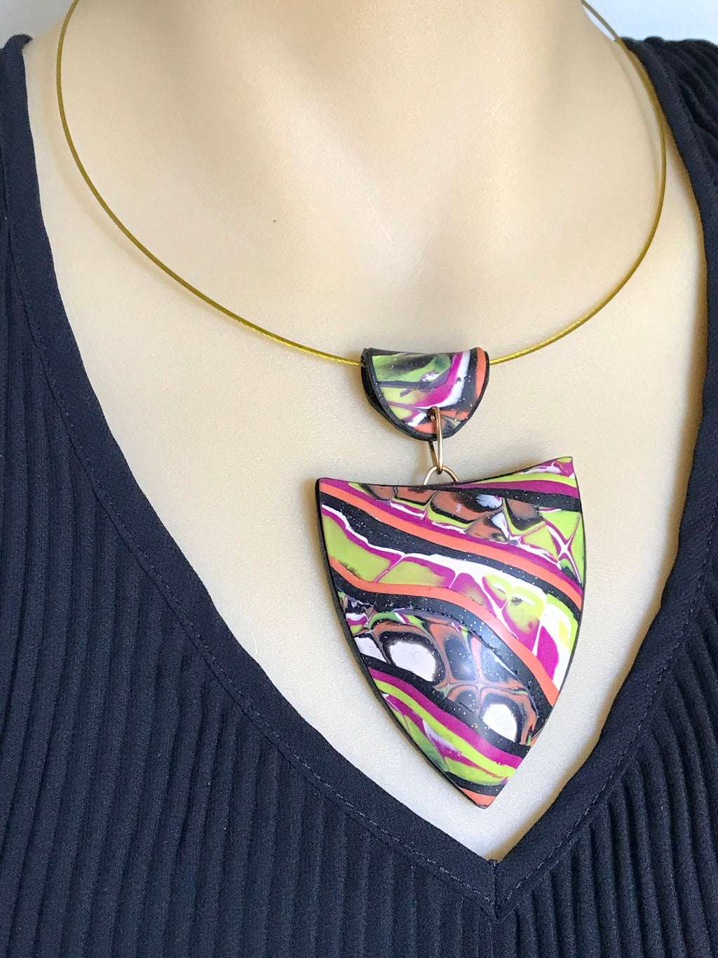 Abstract patchwork pendant necklace worn on mannequin showing statement fit and drape.