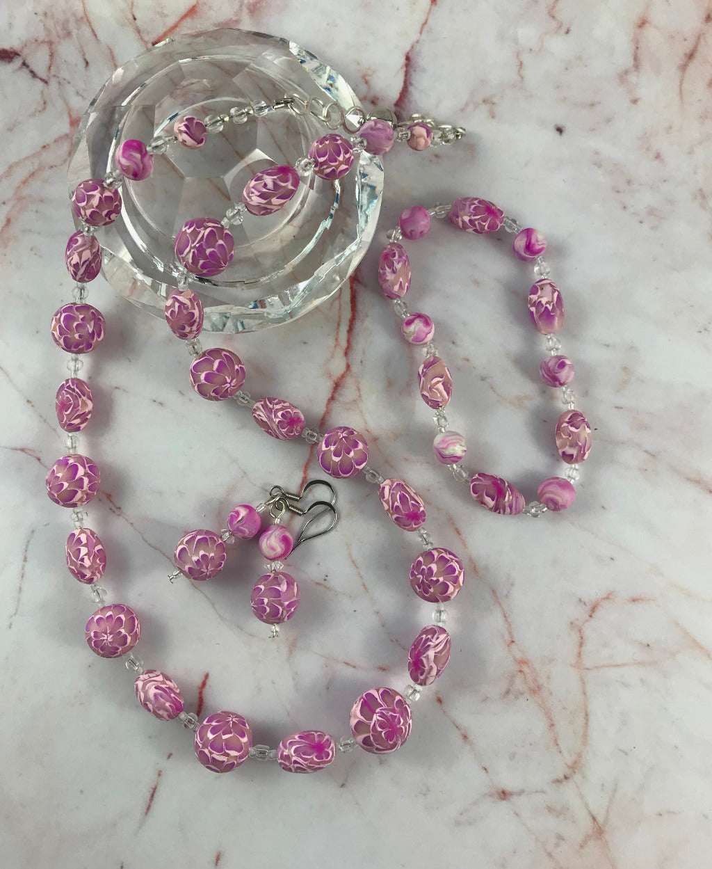 Rennique handmade long pink flower necklace set with matching earrings and bracelet made from polymer clay floral beads.