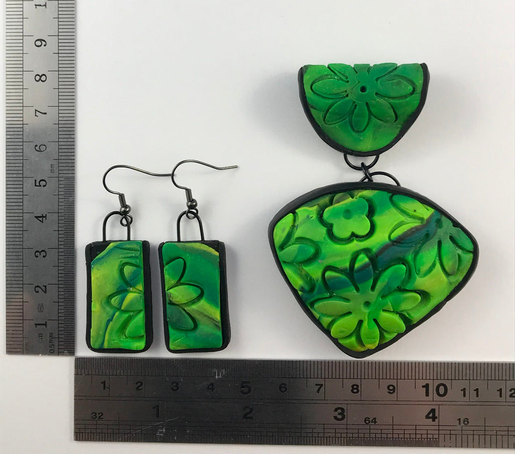 Rennique handmade spring green polymer clay pendant and matching rectangular earrings with carved floral texture and black frame edge