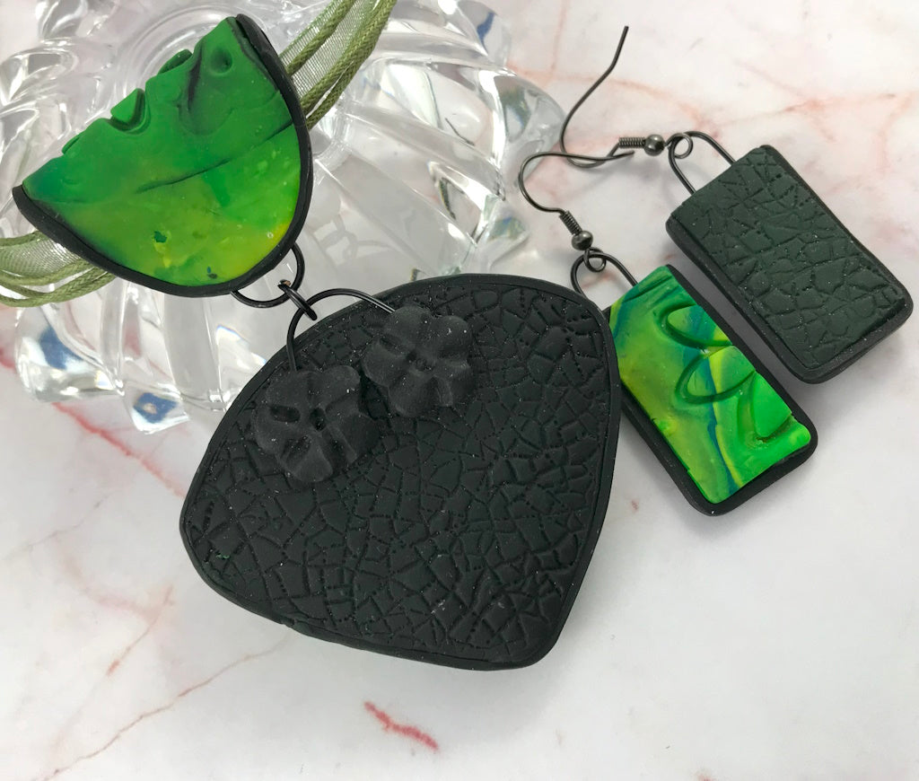 Rennique spring green pendant and matching earrings showing black textured back detail and handcrafted polymer clay floral design