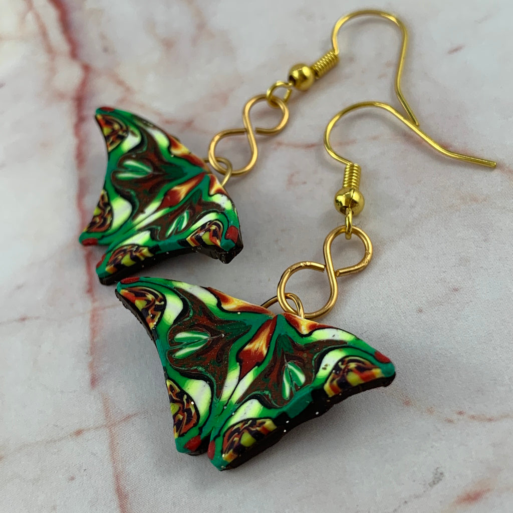 Handmade Rennique butterfly wing earrings with gold hooks and tropical kaleidoscope polymer clay pattern.