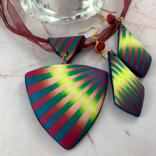 Rennique Studio one-of-a-kind wearable art pendant and earrings set in vibrant colourburst stripes of pink, teal blue, and neon lime, handcrafted in polymer clay with gold-tone findings.