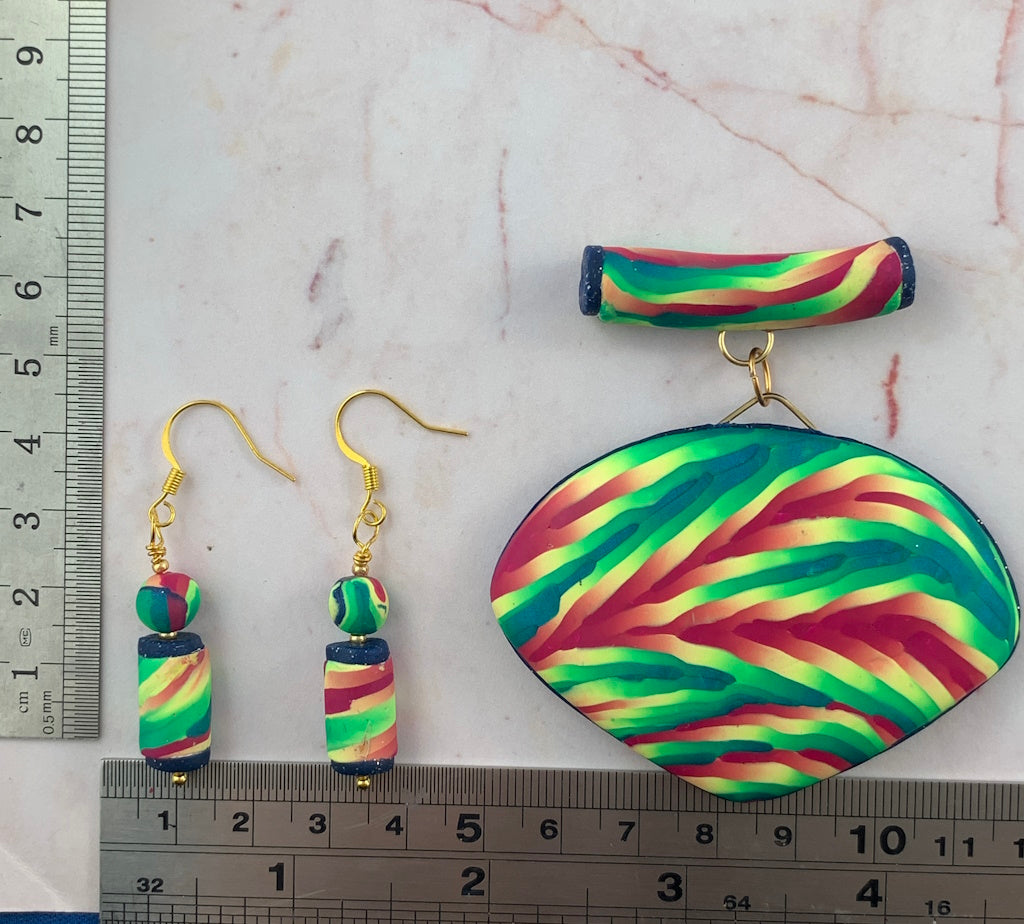 Handmade Rennique colourful statement pendant necklace with matching drop earrings in bold green, pink and teal artisan polymer clay, shown with measurement scale.