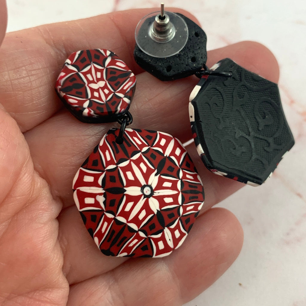 Back view of Rennique designer polymer clay earrings showing textured black backing and handcrafted wearable art finish.