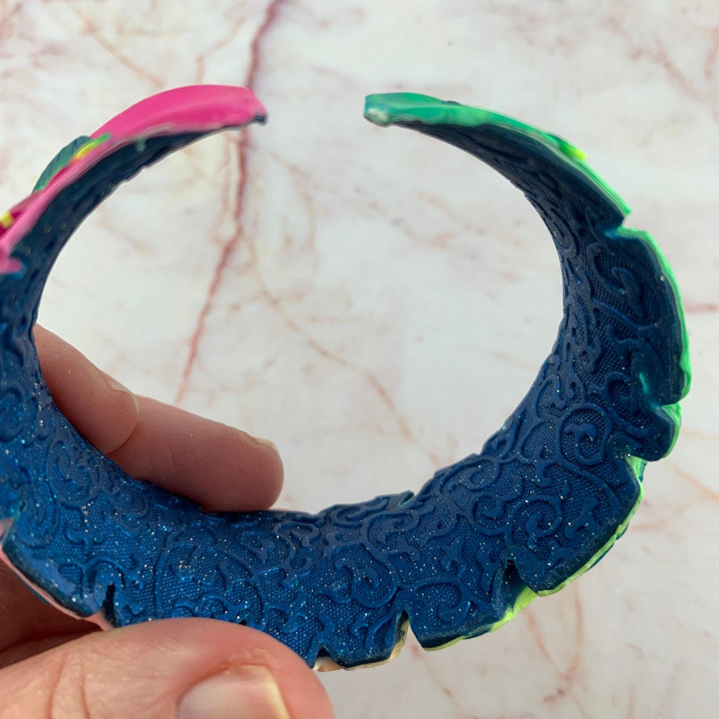 Inner textured view of Rennique designer statement cuff bracelet with embossed navy blue finish and handcrafted wearable art floral exterior.