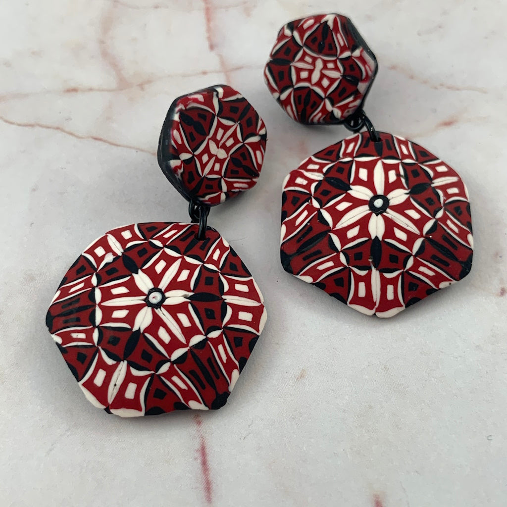 Rennique Studio one-of-a-kind statement drop earrings in bold monochrome red, black and white kaleidoscope pattern wearable art.