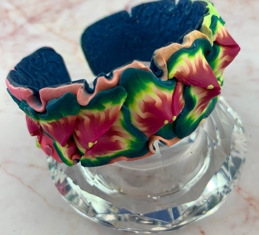 Rennique Studio wearable art tropical floral statement cuff bracelet handmade from polymer clay in vibrant pink, green and blue colours.