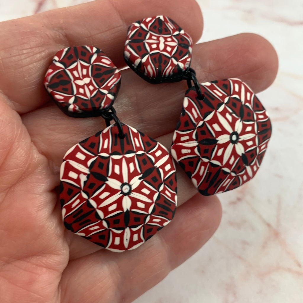 Rennique wearable art handmade statement earrings in polymer clay featuring bold red, black and white geometric mosaic design.